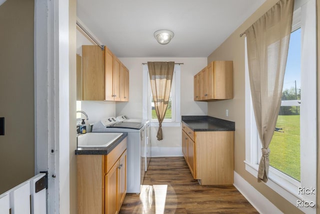laundry area featuring cabinet space, washing machine and clothes dryer, dark wood-style flooring, and baseboards