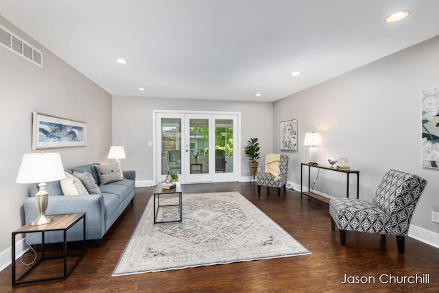 living area with baseboards, wood finished floors, and recessed lighting