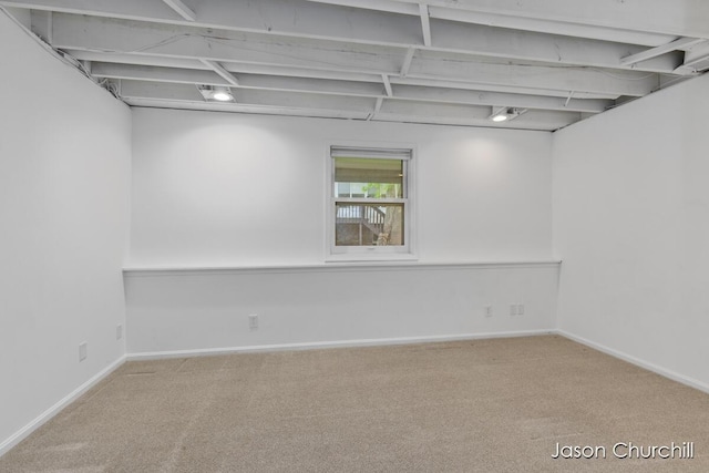 below grade area featuring carpet floors and baseboards