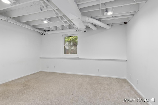 basement featuring carpet flooring and baseboards