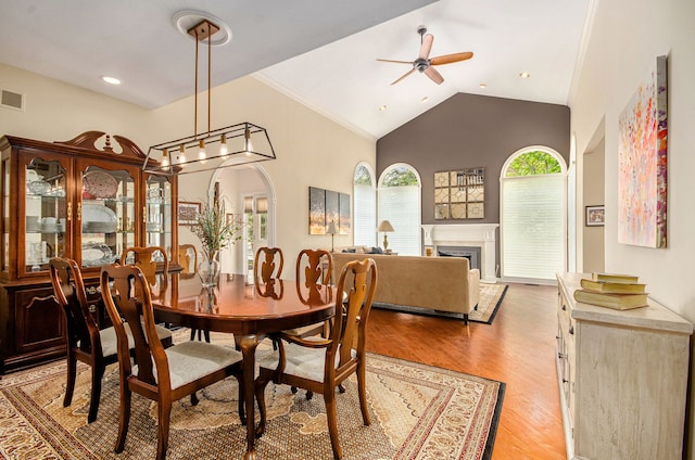 2200 Clearwood, Shelby Twp, MI 48316 - dining space with a ceiling fan, light wood-style flooring, a fireplace, and high vaulted ceiling