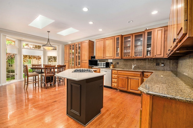 2200 Clearwood, Shelby Twp, MI 48316 - kitchen with crown molding, brown cabinets, appliances with stainless steel finishes, a skylight, and tasteful backsplash