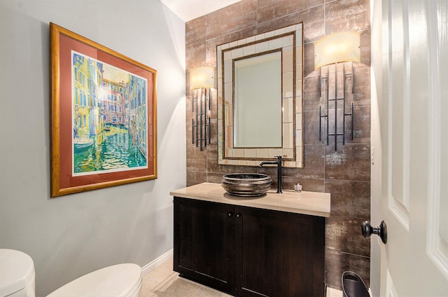 2200 Clearwood, Shelby Twp, MI 48316 - bathroom featuring toilet, vanity, tile walls, and baseboards