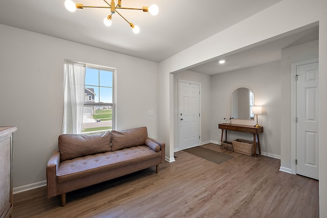 346 Quartz Way, White Lake, MI 48386 - sitting room featuring light wood-style floors, baseboards, and a chandelier