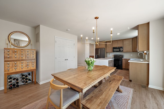 346 Quartz Way, White Lake, MI 48386 - dining room featuring a chandelier, light wood finished floors, and baseboards