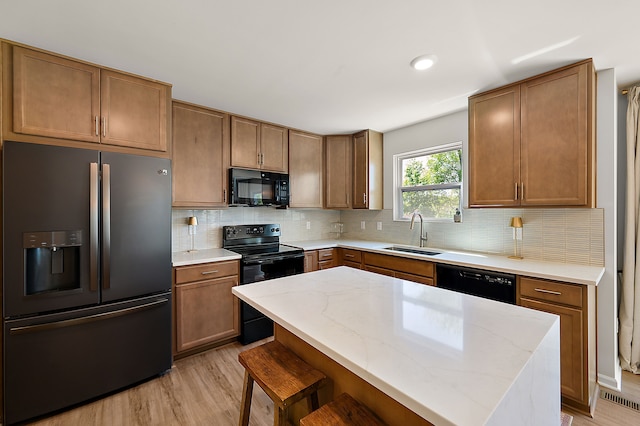 346 Quartz Way, White Lake, MI 48386 - kitchen with black appliances, a sink, light wood-type flooring, decorative backsplash, and light stone countertops