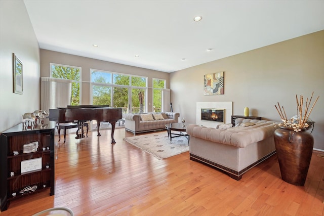7039 Timberview Trl, West Bloomfield, MI 48322 - living room with light wood-type flooring, a glass covered fireplace, and recessed lighting