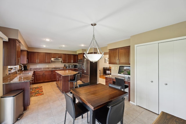 7039 Timberview Trl, West Bloomfield, MI 48322 - kitchen featuring a sink, under cabinet range hood, light tile patterned flooring, light stone counters, and a center island