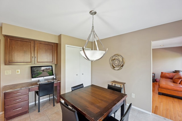 7039 Timberview Trl, West Bloomfield, MI 48322 - dining area with light tile patterned floors, a desk, and baseboards