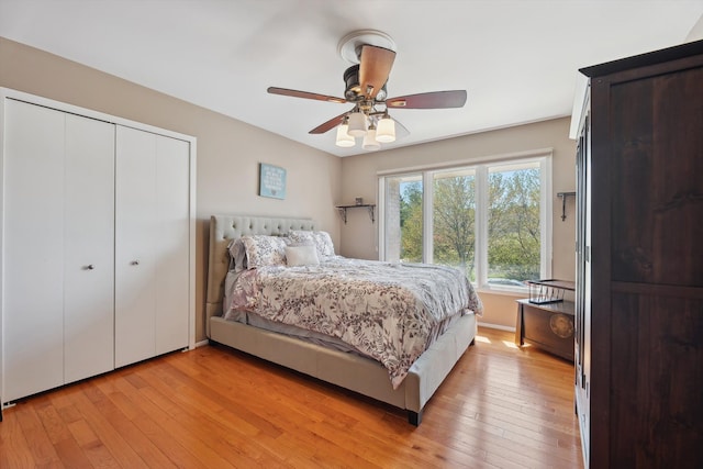 7039 Timberview Trl, West Bloomfield, MI 48322 - bedroom with light wood-style flooring, a closet, and a ceiling fan