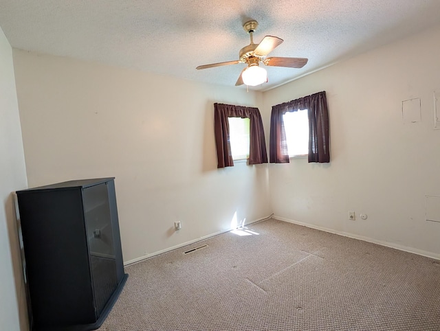 5062 Kendall Dr, Burton, MI 48509 - carpeted empty room featuring ceiling fan, a textured ceiling, and baseboards