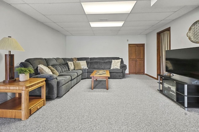 carpeted living area featuring a drop ceiling
