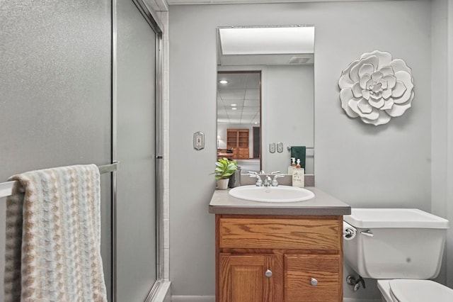 full bath with an enclosed shower, vanity, and toilet