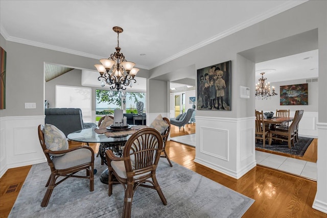 32630 Jefferson Ave, Saint Clair Shores, MI 48082 - dining area featuring a chandelier, ornamental molding, wood finished floors, a wainscoted wall, and a decorative wall