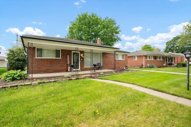 27607 Buckingham St, Livonia, MI 48154 - ranch-style home with brick siding, a front lawn, covered porch, and a chimney