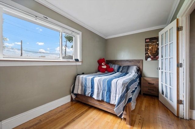 27607 Buckingham St, Livonia, MI 48154 - bedroom with wood finished floors, crown molding, and baseboards