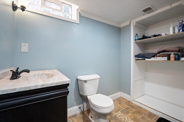 27607 Buckingham St, Livonia, MI 48154 - bathroom featuring crown molding, stone tile floors, toilet, vanity, and baseboards