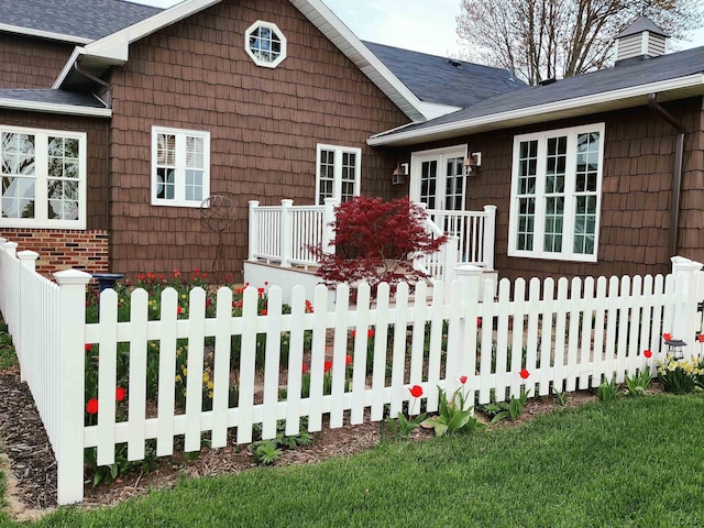view of front of house with fence and a wooden deck