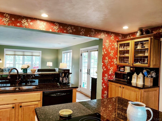 kitchen featuring a sink, black dishwasher, wallpapered walls, dark stone countertops, and stainless steel microwave