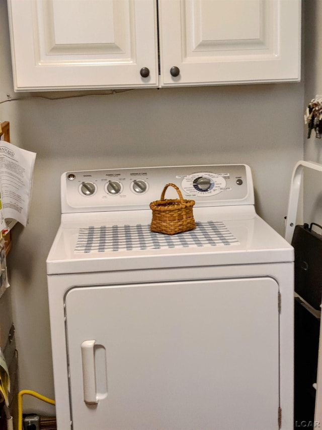laundry area with washer / clothes dryer and cabinet space