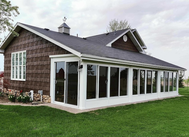 9642 Fike Rd, Blissfield, MI 49228 - rear view of property featuring roof with shingles, a sunroom, and a lawn
