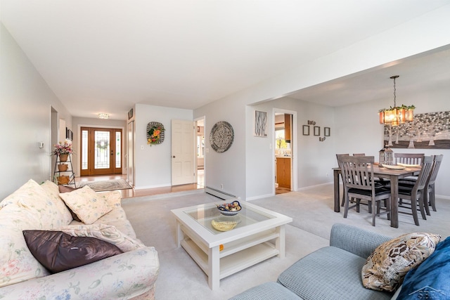 2303 Wilmington St, Midland, MI 48642 - living area with a baseboard heating unit, light carpet, a chandelier, and baseboards