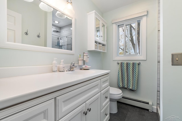 2303 Wilmington St, Midland, MI 48642 - bathroom featuring baseboard heating, toilet, vanity, tile patterned floors, and a shower