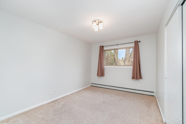 2303 Wilmington St, Midland, MI 48642 - spare room featuring baseboard heating, carpet flooring, and baseboards