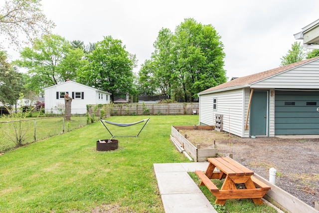 view of yard with a fire pit