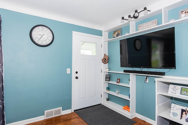 entryway with wood finished floors and baseboards