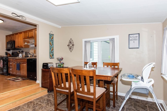 dining room featuring crown molding, dark marble finish floors, and baseboards