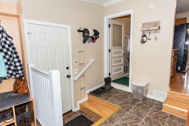 mudroom featuring baseboards and ornamental molding