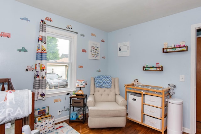 living area with wood finished floors and baseboards