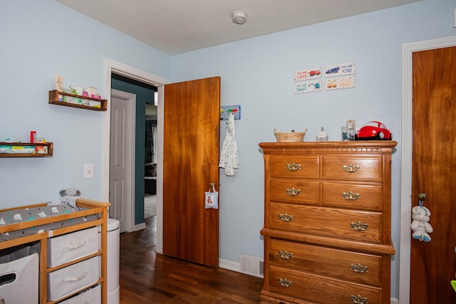 bedroom featuring dark wood-type flooring and baseboards