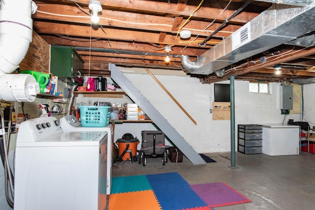 basement featuring separate washer and dryer, electric panel, and stairs