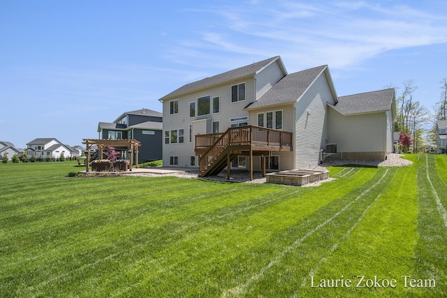 back of property featuring stairs, a wooden deck, a lawn, a patio, and roof with shingles
