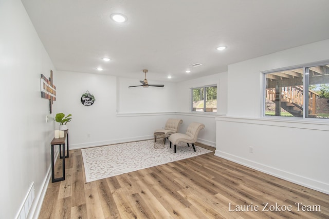 living area featuring a ceiling fan, light wood-style flooring, recessed lighting, and baseboards