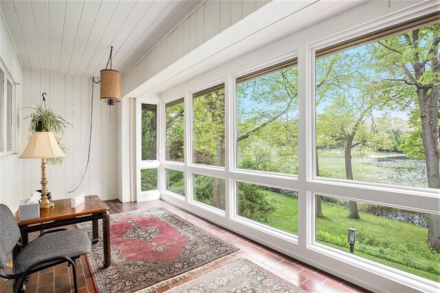 sunroom with wooden ceiling and wood walls