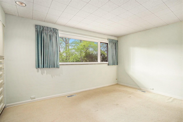 carpeted empty room with baseboards