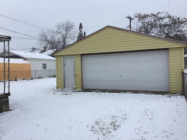 19595 Waldron St, Roseville, MI 48066 - snow covered garage with a detached garage and fence