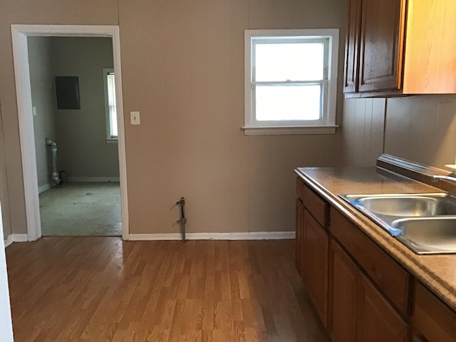 19595 Waldron St, Roseville, MI 48066 - kitchen with a sink, wood finished floors, electric panel, and baseboards