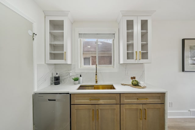 bar area with a sink, stainless steel dishwasher, backsplash, and wood finished floors
