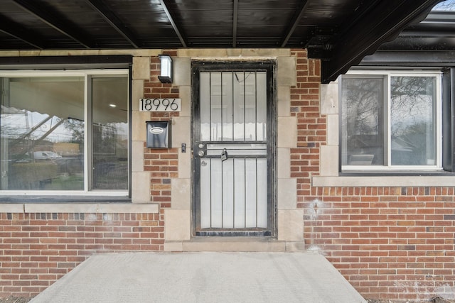entrance to property with brick siding