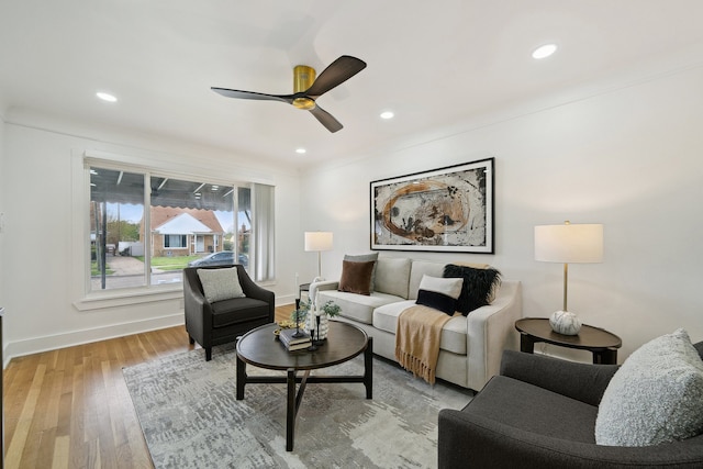living room featuring a ceiling fan, baseboards, light wood-style floors, and recessed lighting