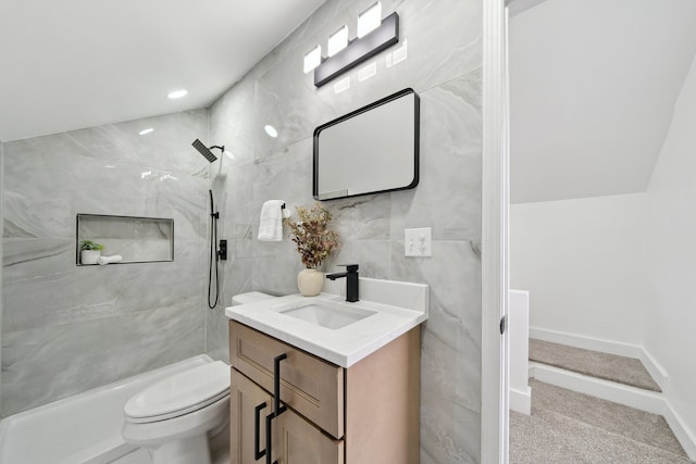 full bathroom featuring a walk in shower, vanity, toilet, and tile walls