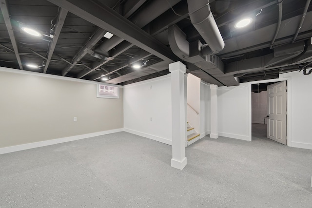 below grade area with stairs and baseboards
