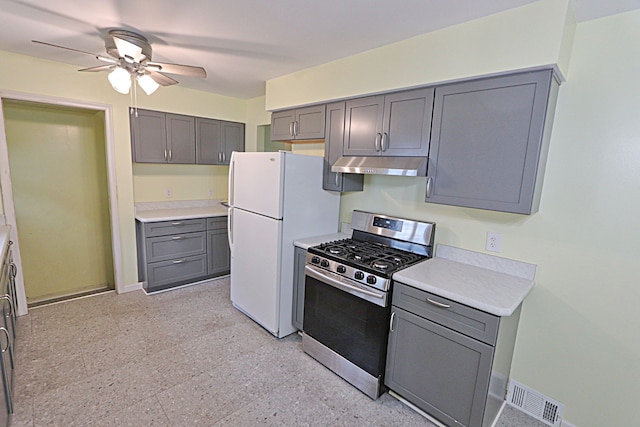 9963 Arnold, Redford, MI 48239 - kitchen featuring stainless steel range with gas stovetop, under cabinet range hood, gray cabinets, and freestanding refrigerator