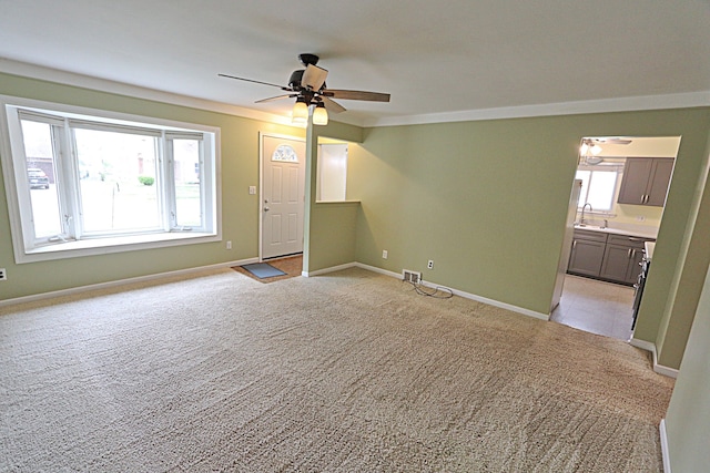 9963 Arnold, Redford, MI 48239 - unfurnished living room featuring a ceiling fan, a sink, light colored carpet, baseboards, and ornamental molding