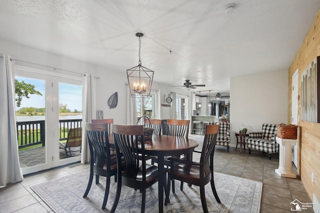 3131 Morin Point St, Erie, MI 48133 - dining space with a chandelier, light tile patterned flooring, a ceiling fan, and a water view