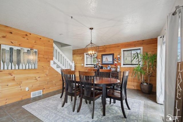 3131 Morin Point St, Erie, MI 48133 - dining area with wood walls, stairs, and a chandelier